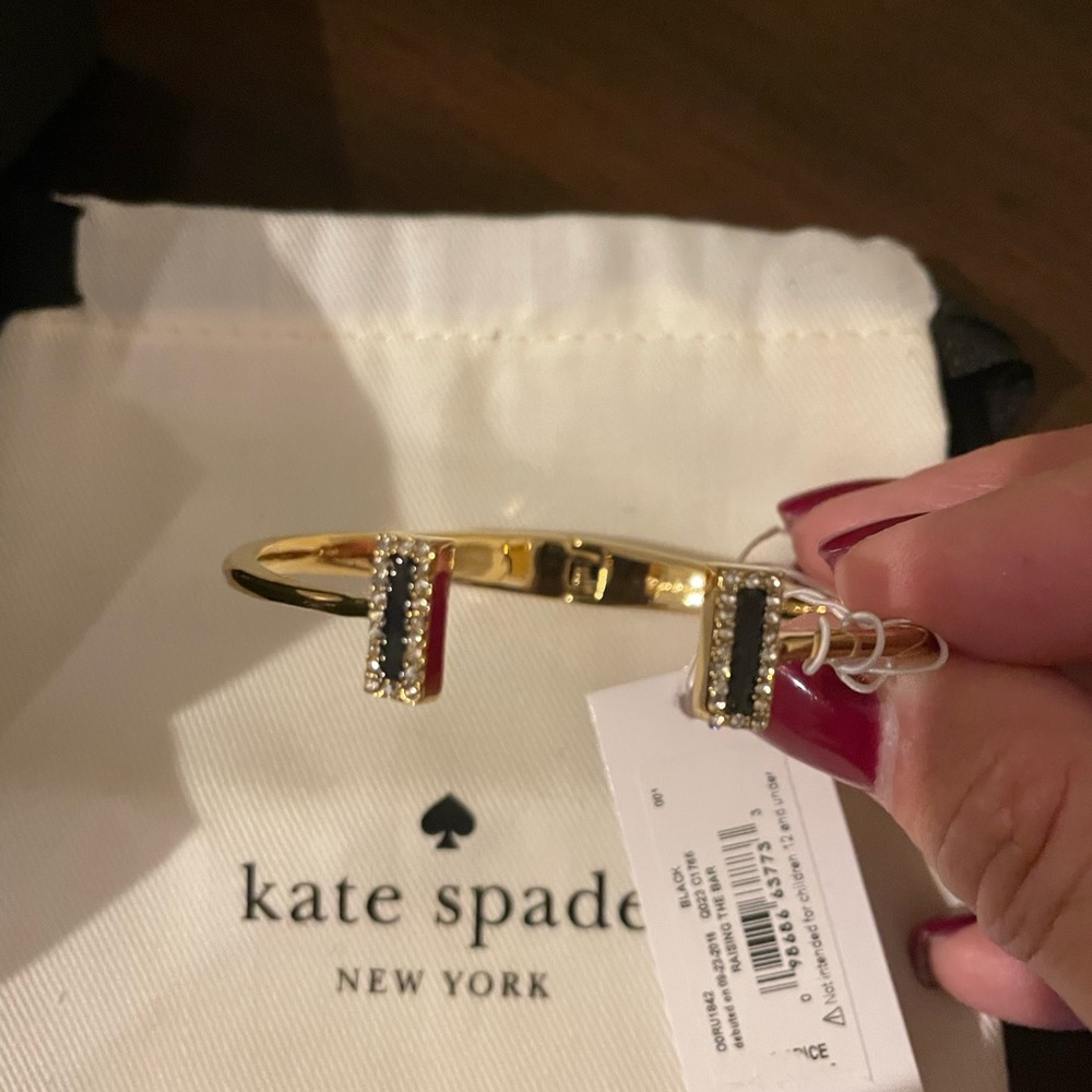 New, with tags, gold bracelet with navy and “diamond” stones.